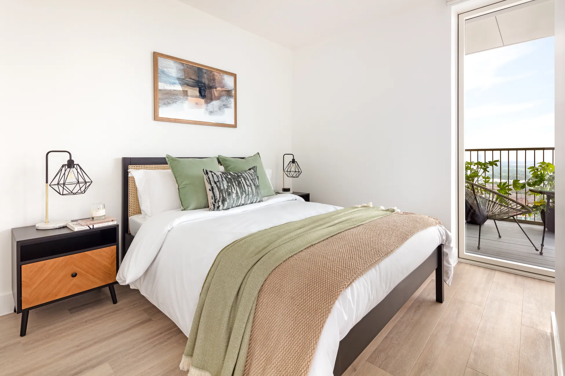 The Verdean Studio sleeping area with dressed bed and green accents