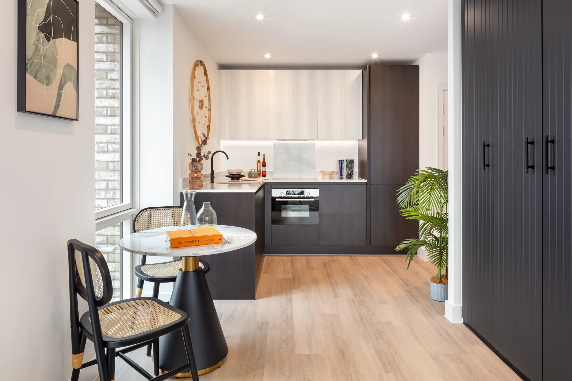 The Verdean Studio compact dining area adjacent to fitted kitchen